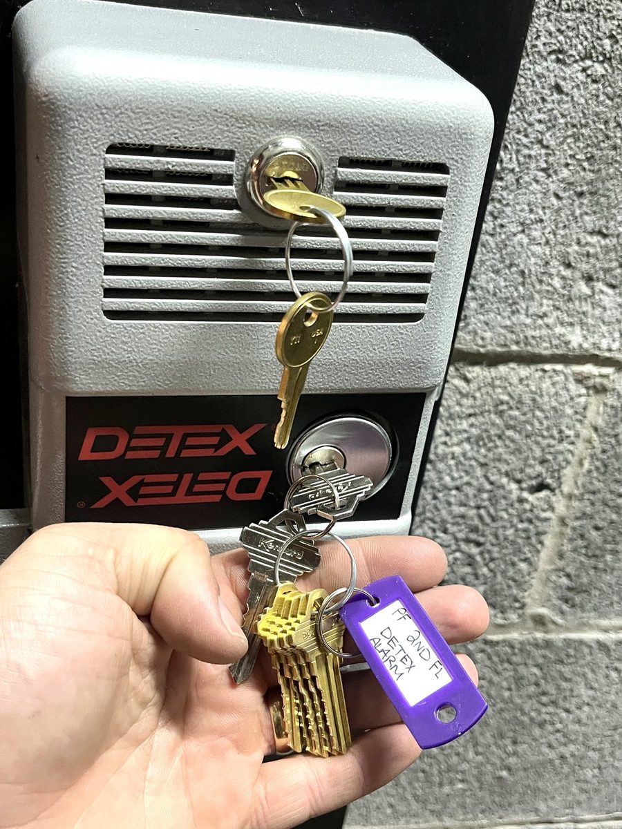 A Detex exit device serviced on a commercial door