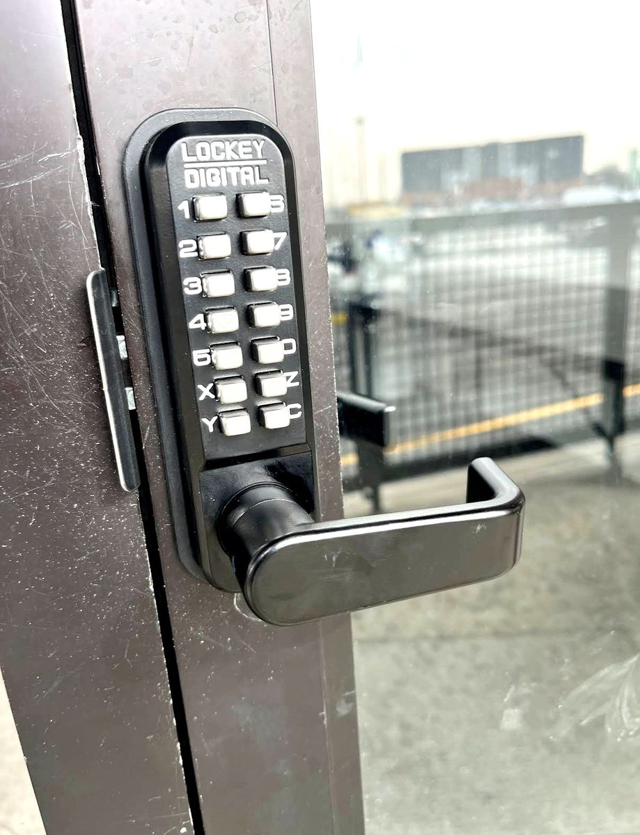 A mechanical pushbutton lever — coded entry with no batteries and no wiring