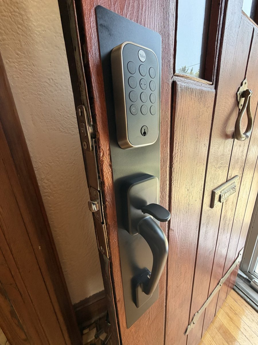 The finished conversion — the customer's own keypad lock, thumbturn and lever on a single plate over the old mortise pocket