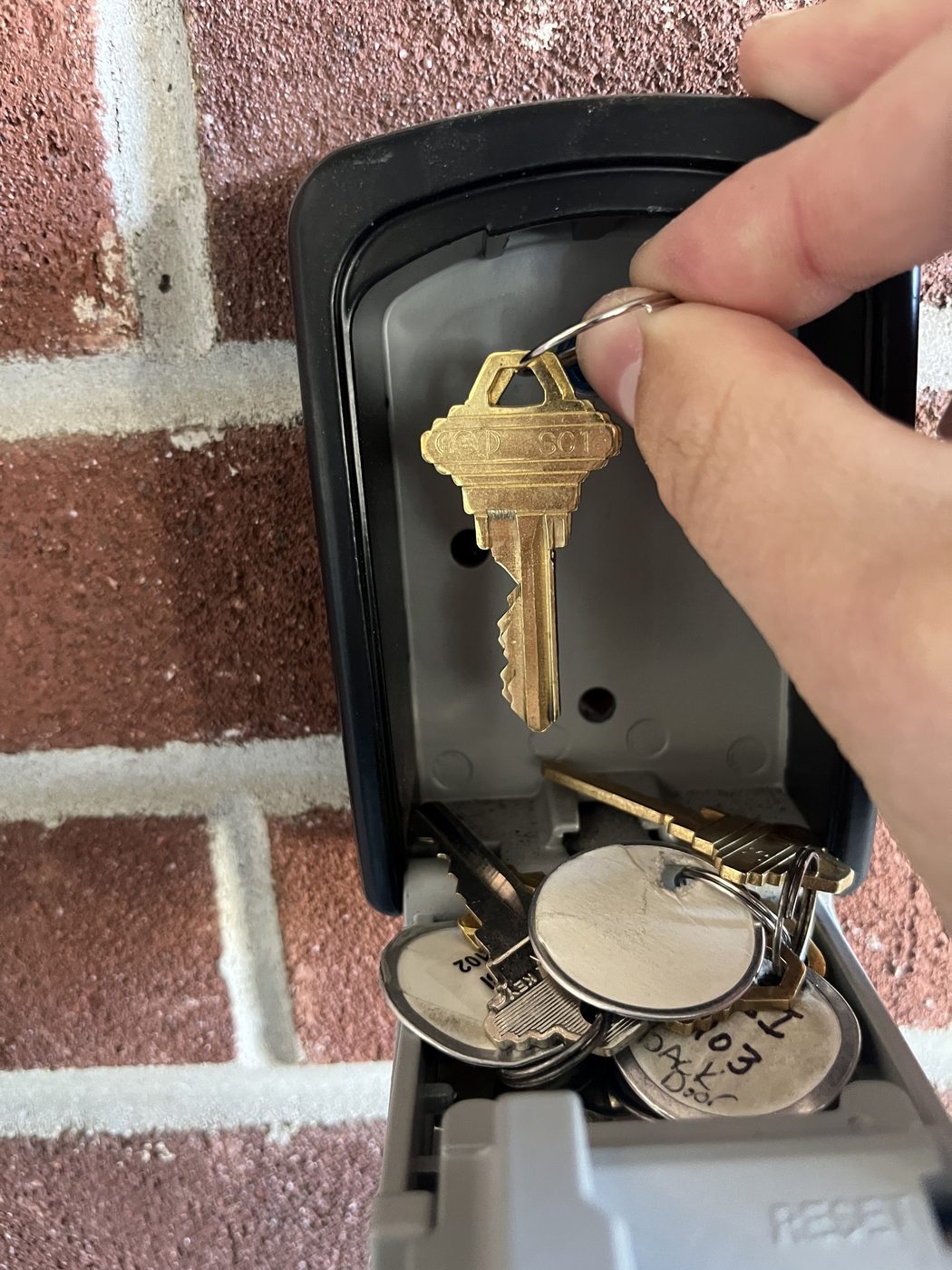 Keys and tagged fobs going into a wall-mounted key box