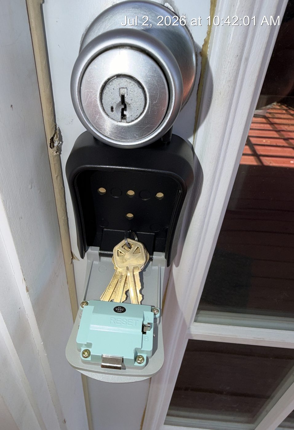 A key box mounted beside the deadbolt it opens