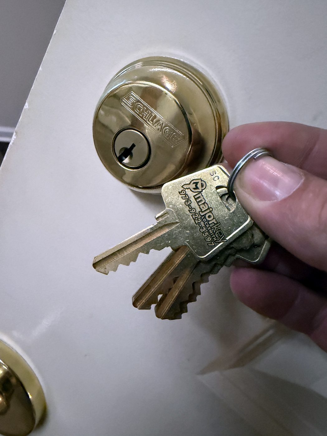 A Schlage deadbolt rekeyed, with its new keys before we leave