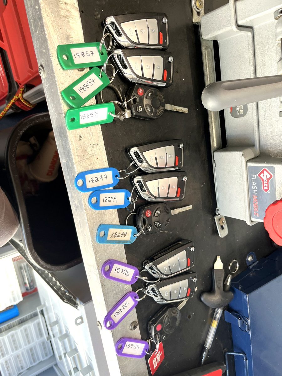 The key board in the van — blanks and fobs tagged and ready